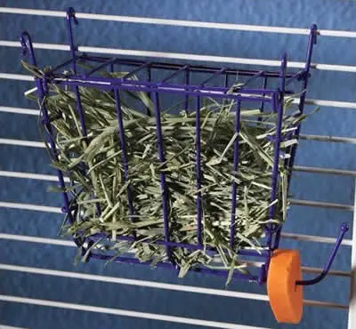 A hay rack hanging on a cage wall